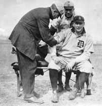 Al Summers has his arm worked on by Tiger trainer Harry Tuthill, first baseman Del Gainer looks on.