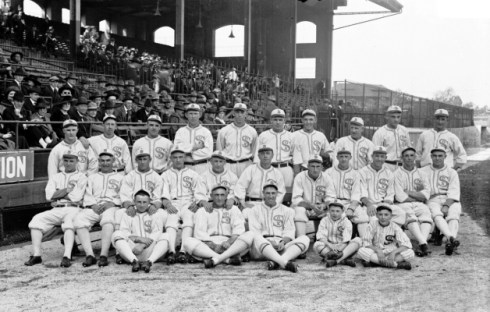Group portrait of American League's Chicago White Sox baseball team posing in front of a section of the grandstands on the field at Comiskey Park, Chicago, Illinois, 1917.