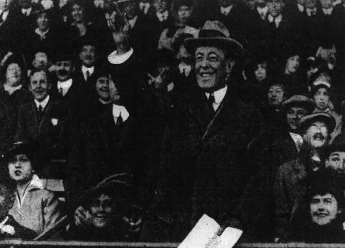 Wilson, program in hand, after throwing first pitch to umpire Billy Evans in 1915.
